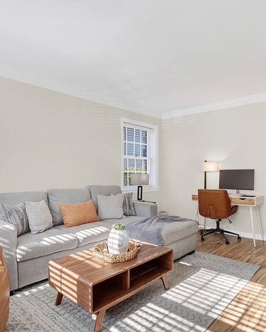 Ardsley living room with sofa, leather chair, and desk